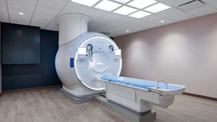 MRI scanner in a clean medical imaging room with a sliding patient table ready for use